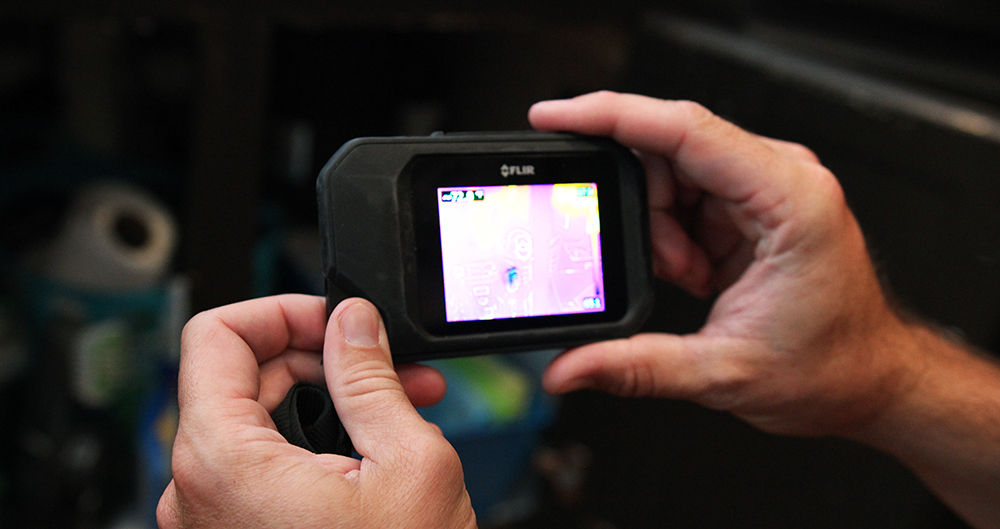 Crawford using a thermal imaging device while performing home inspection services